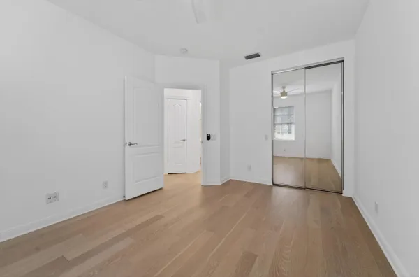 a bathroom with a shower sink vanity mirror and toilet