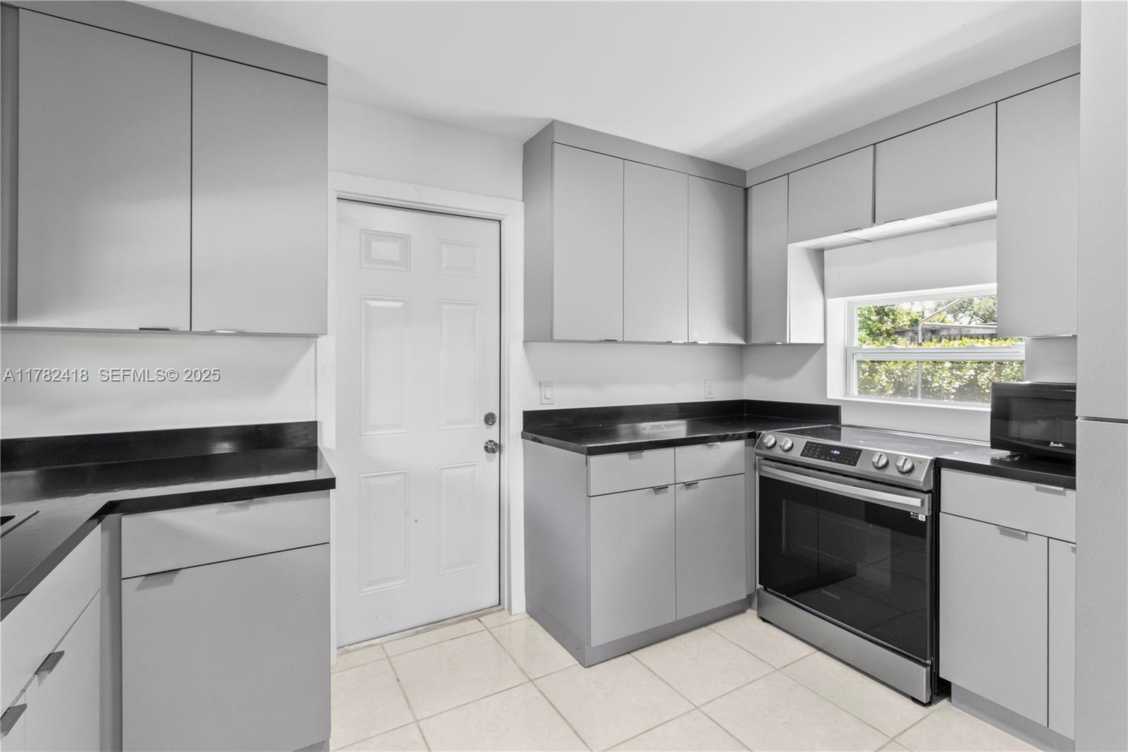 8350 Southwest 98th Street Miami, FL 33156 - Photo 14 of 67 a kitchen with white cabinets and appliances