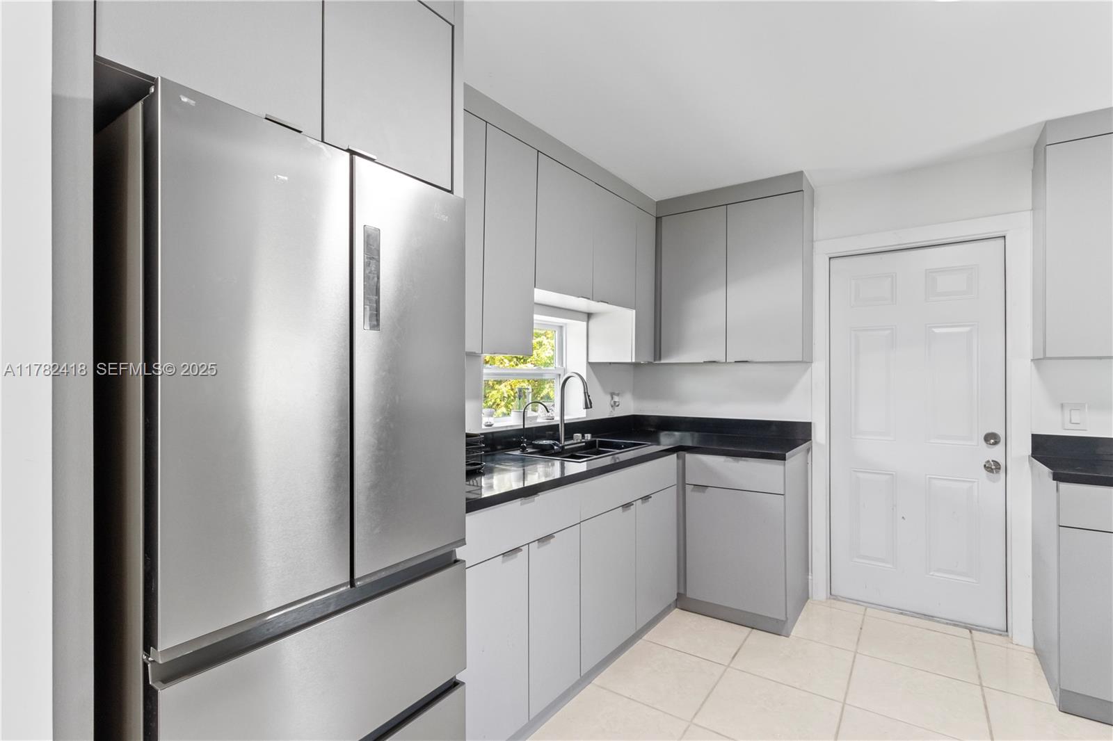 8350 Southwest 98th Street Miami, FL 33156 - Photo 15 of 67 a kitchen with stainless steel appliances granite countertop a refrigerator and a sink