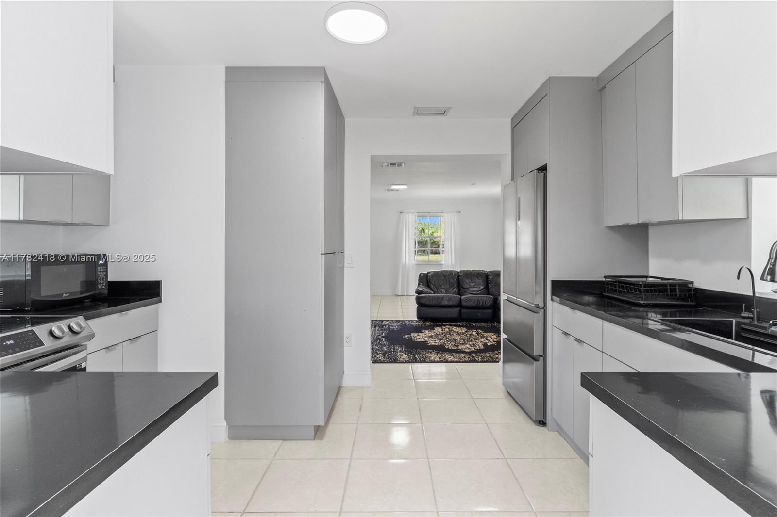 8350 Southwest 98th Street Miami, FL 33156 - Photo 16 of 67 a kitchen with a stove a sink and a refrigerator