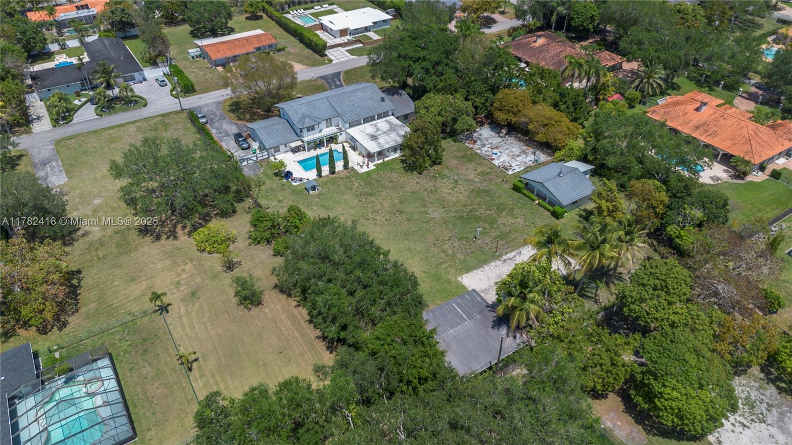 8350 Southwest 98th Street Miami, FL 33156 - Photo 2 of 67 an aerial view of residential house with outdoor space and trees all around