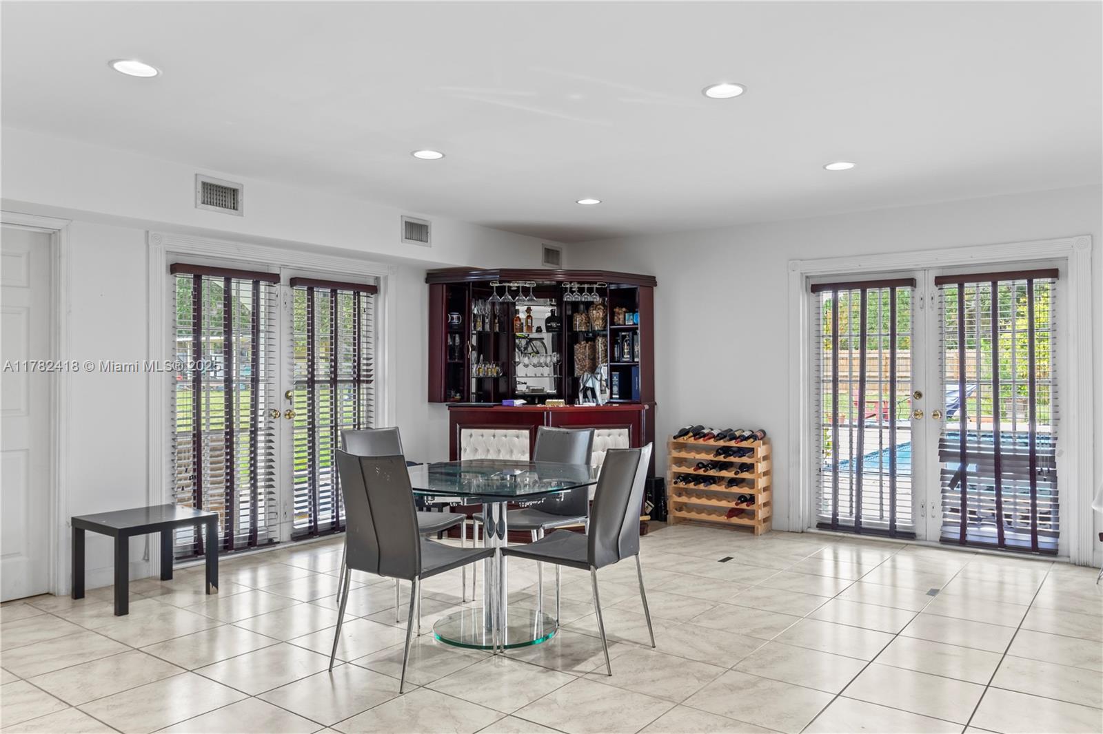 8350 Southwest 98th Street Miami, FL 33156 - Photo 22 of 67 a dining room with furniture and large windows
