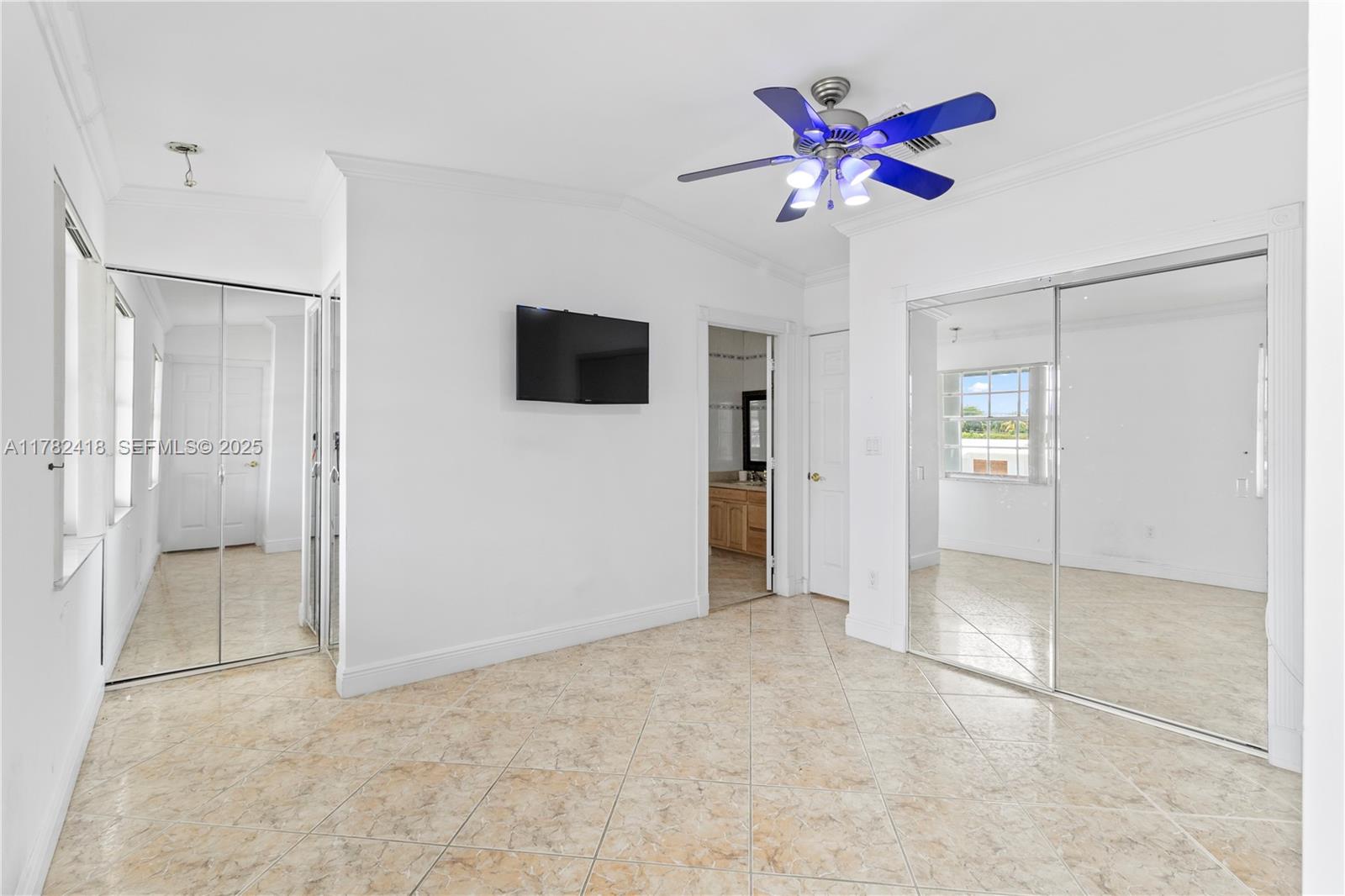 8350 Southwest 98th Street Miami, FL 33156 - Photo 25 of 67 a view of an empty room with a ceiling fan and a window