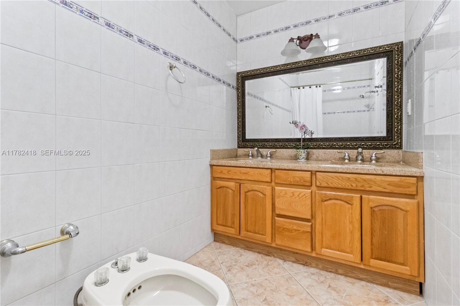 8350 Southwest 98th Street Miami, FL 33156 - Photo 28 of 67 a bathroom with a sink vanity and mirror