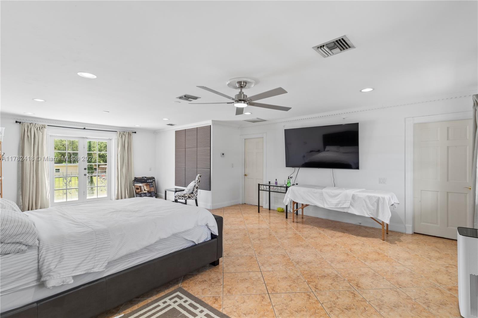 8350 Southwest 98th Street Miami, FL 33156 - Photo 30 of 67 a bedroom with a bed and a flat screen tv