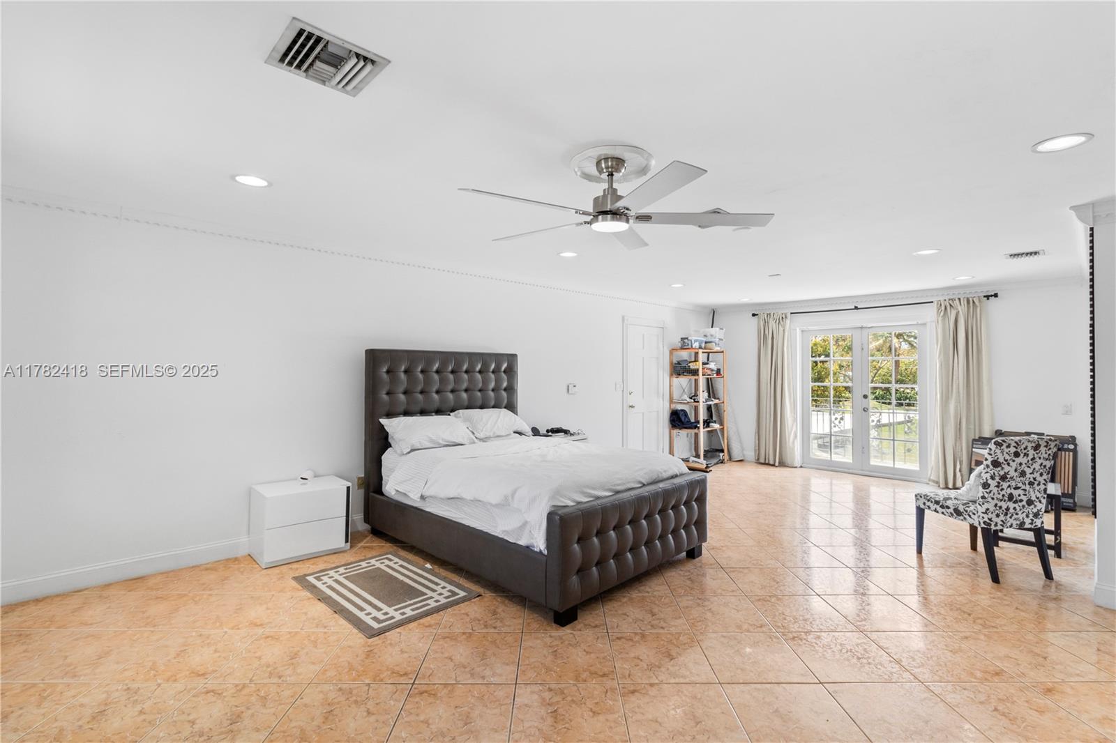 8350 Southwest 98th Street Miami, FL 33156 - Photo 31 of 67 a spacious bedroom with a bed a couch and a large window