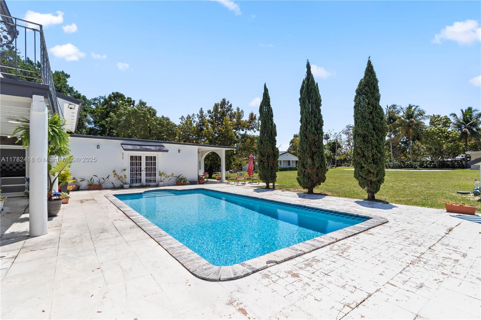 8350 Southwest 98th Street Miami, FL 33156 - Photo 39 of 67 a view of a swimming pool with a patio