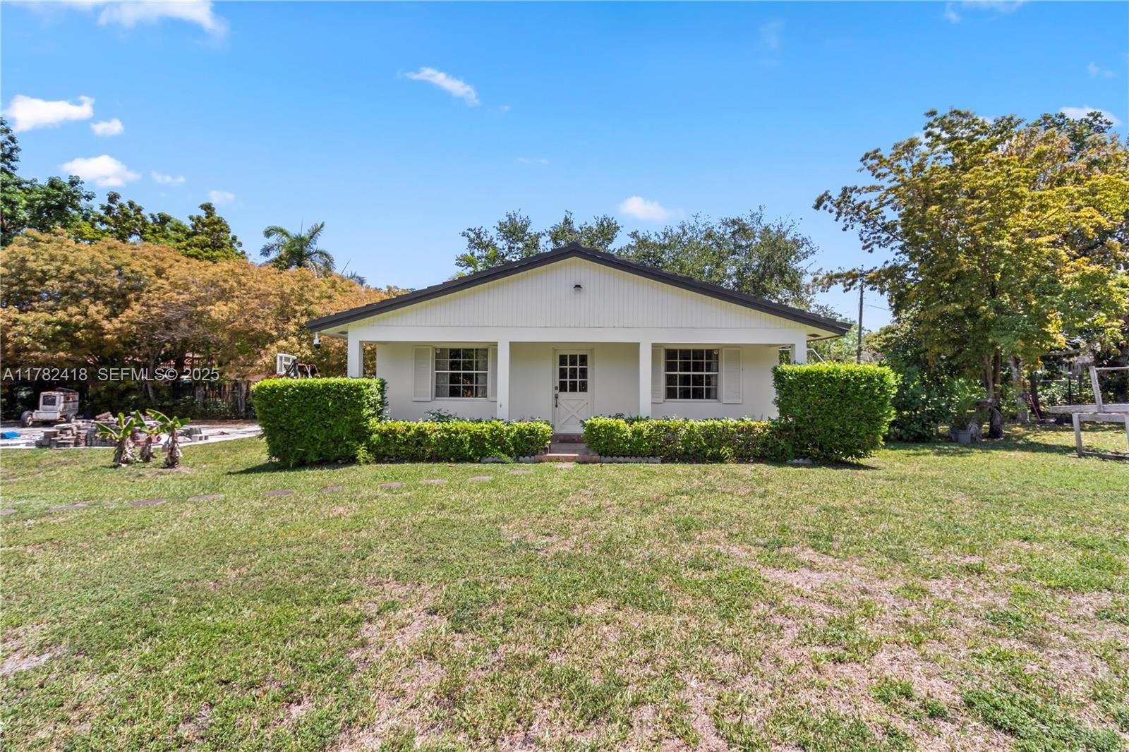 8350 Southwest 98th Street Miami, FL 33156 - Photo 40 of 67 a front view of a house with a yard