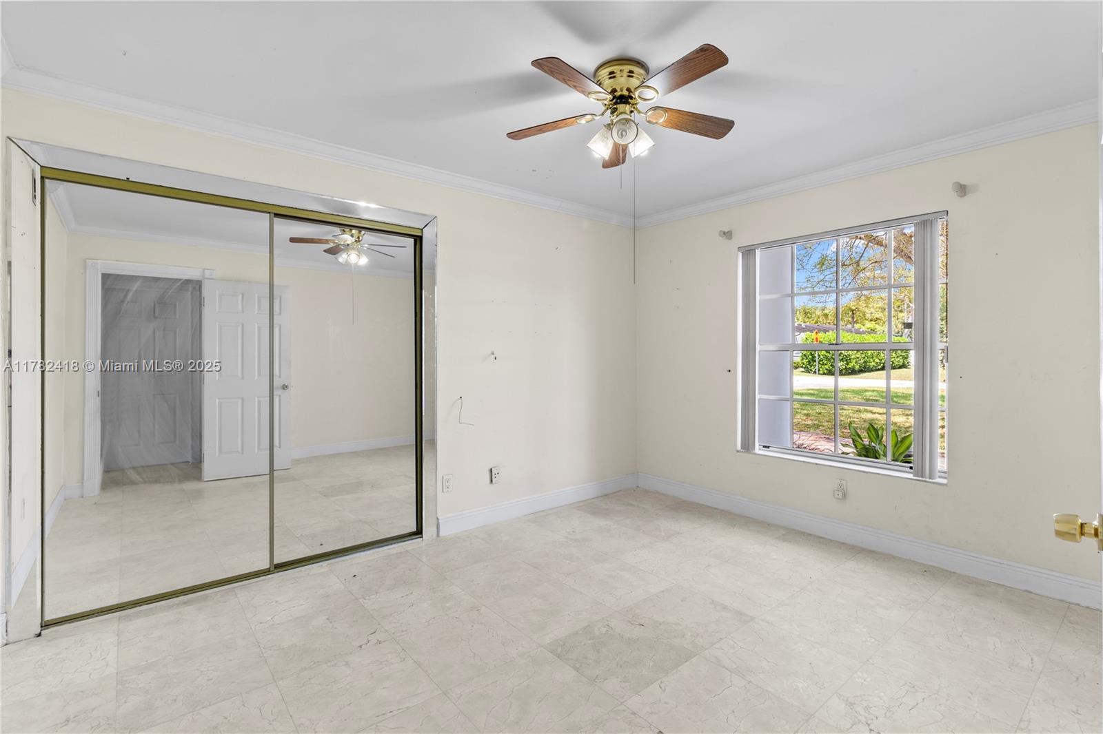 8350 Southwest 98th Street Miami, FL 33156 - Photo 49 of 67 an empty room with a window and a ceiling fan