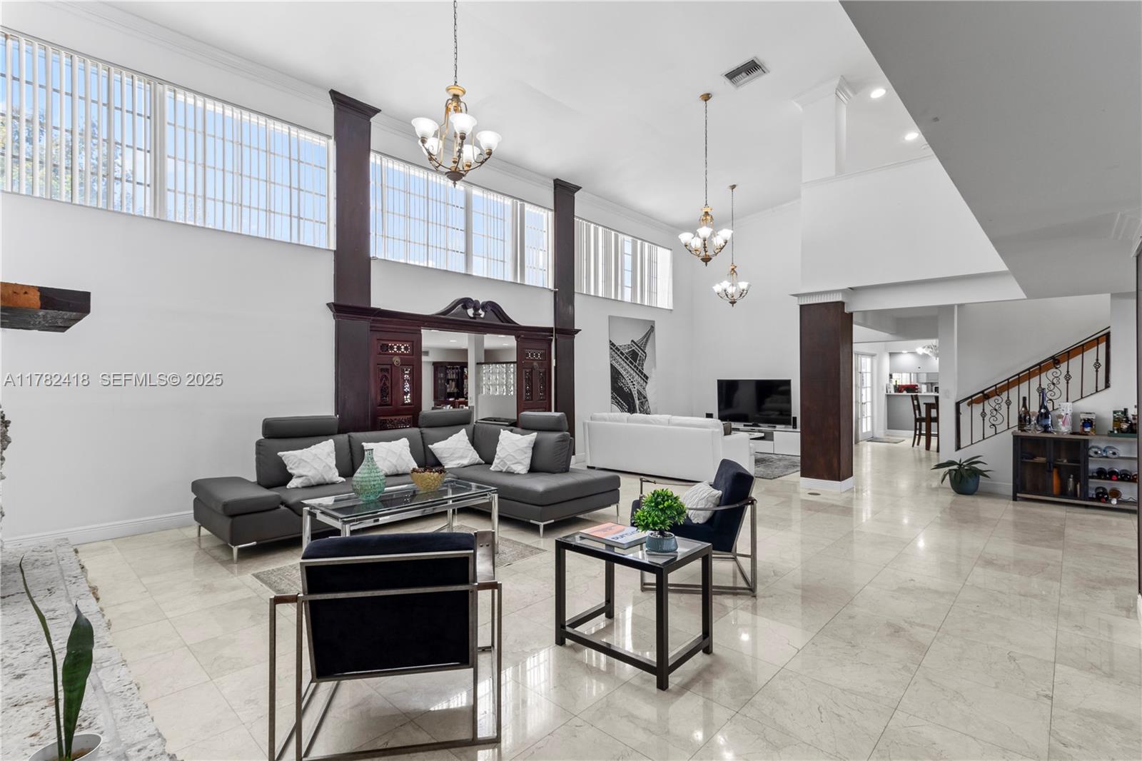 8350 Southwest 98th Street Miami, FL 33156 - Photo 7 of 67 a living room with furniture a chandelier and kitchen view