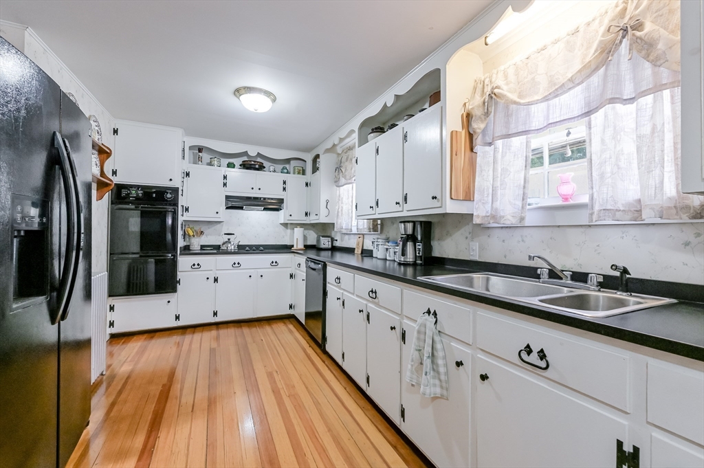147 Shirley Street Pepperell, MA 01463 - Photo 16 of 42 a kitchen with lot of cabinets and wooden floor