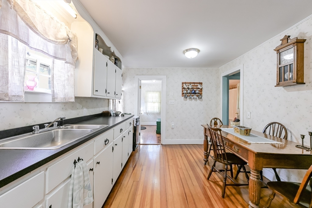 147 Shirley Street Pepperell, MA 01463 - Photo 18 of 42 a kitchen that has a table chairs in it and a window
