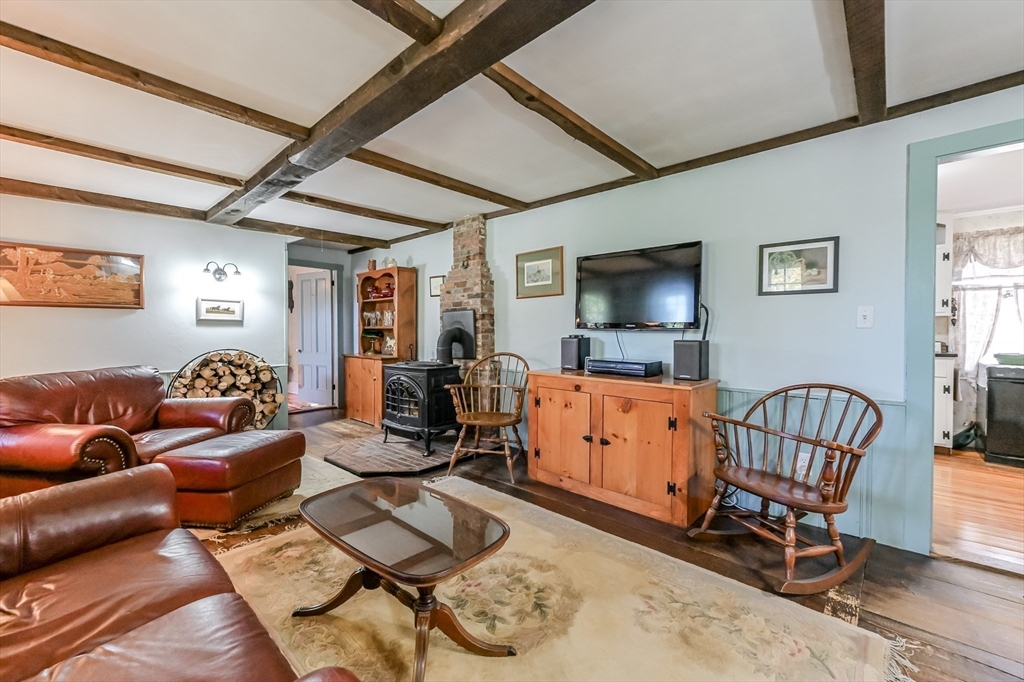 147 Shirley Street Pepperell, MA 01463 - Photo 20 of 42 a living room with furniture a flat screen tv and a window