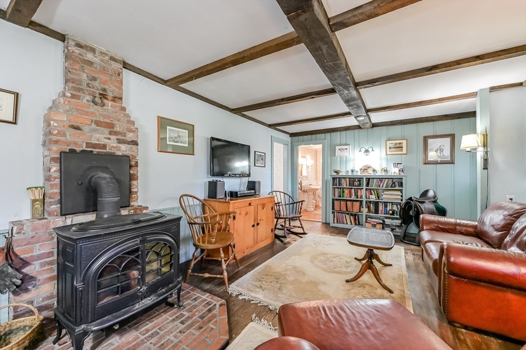 147 Shirley Street Pepperell, MA 01463 - Photo 21 of 42 a living room with furniture and a fireplace