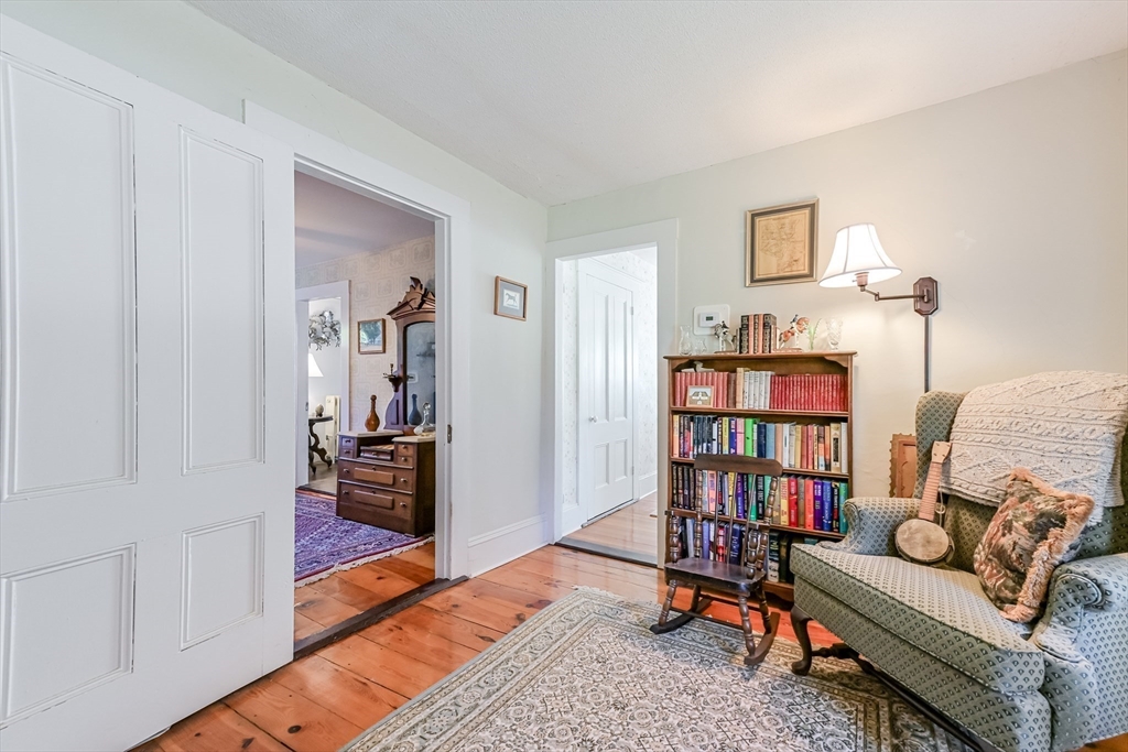 147 Shirley Street Pepperell, MA 01463 - Photo 26 of 42 a living room with furniture and a book shelf