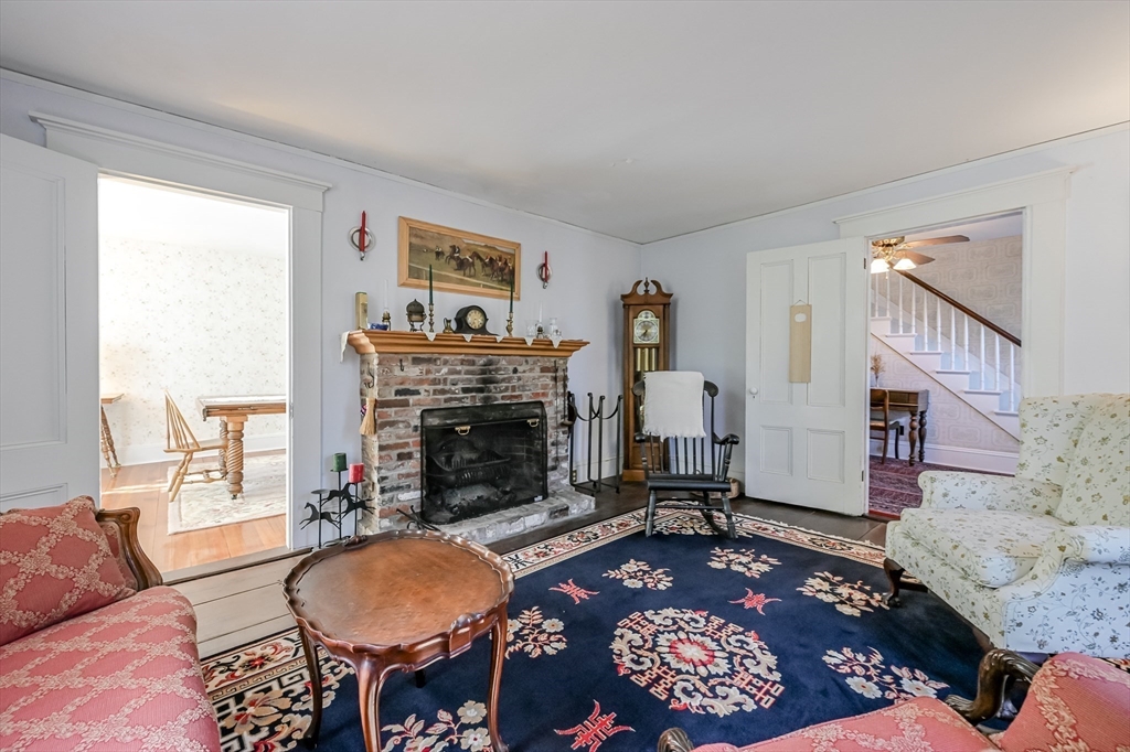 147 Shirley Street Pepperell, MA 01463 - Photo 29 of 42 a living room with furniture a rug and a fireplace