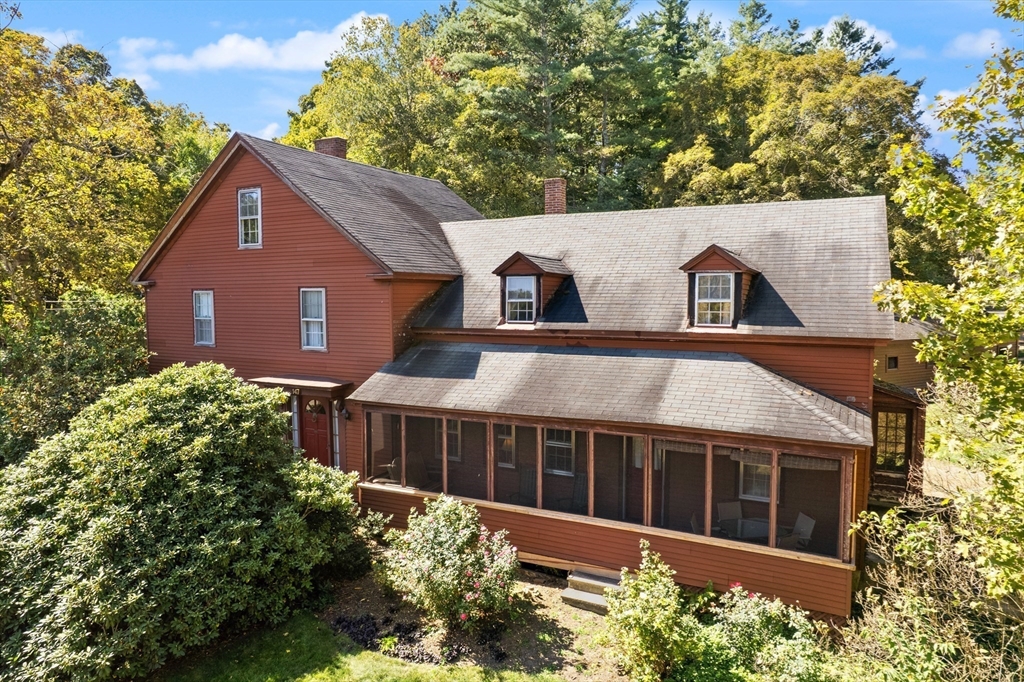 147 Shirley Street Pepperell, MA 01463 - Photo 3 of 42 front view of a house with a garden