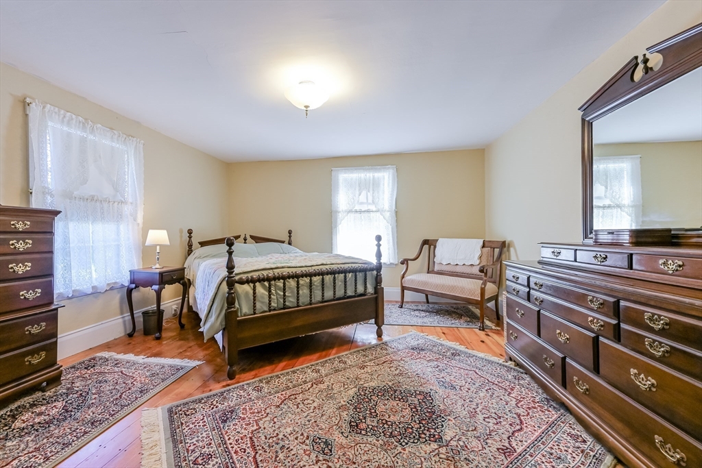 147 Shirley Street Pepperell, MA 01463 - Photo 32 of 42 a bedroom with a bed and a dresser in it