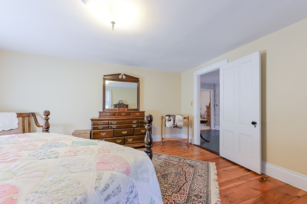 147 Shirley Street Pepperell, MA 01463 - Photo 33 of 42 a bedroom with a bed and a dresser