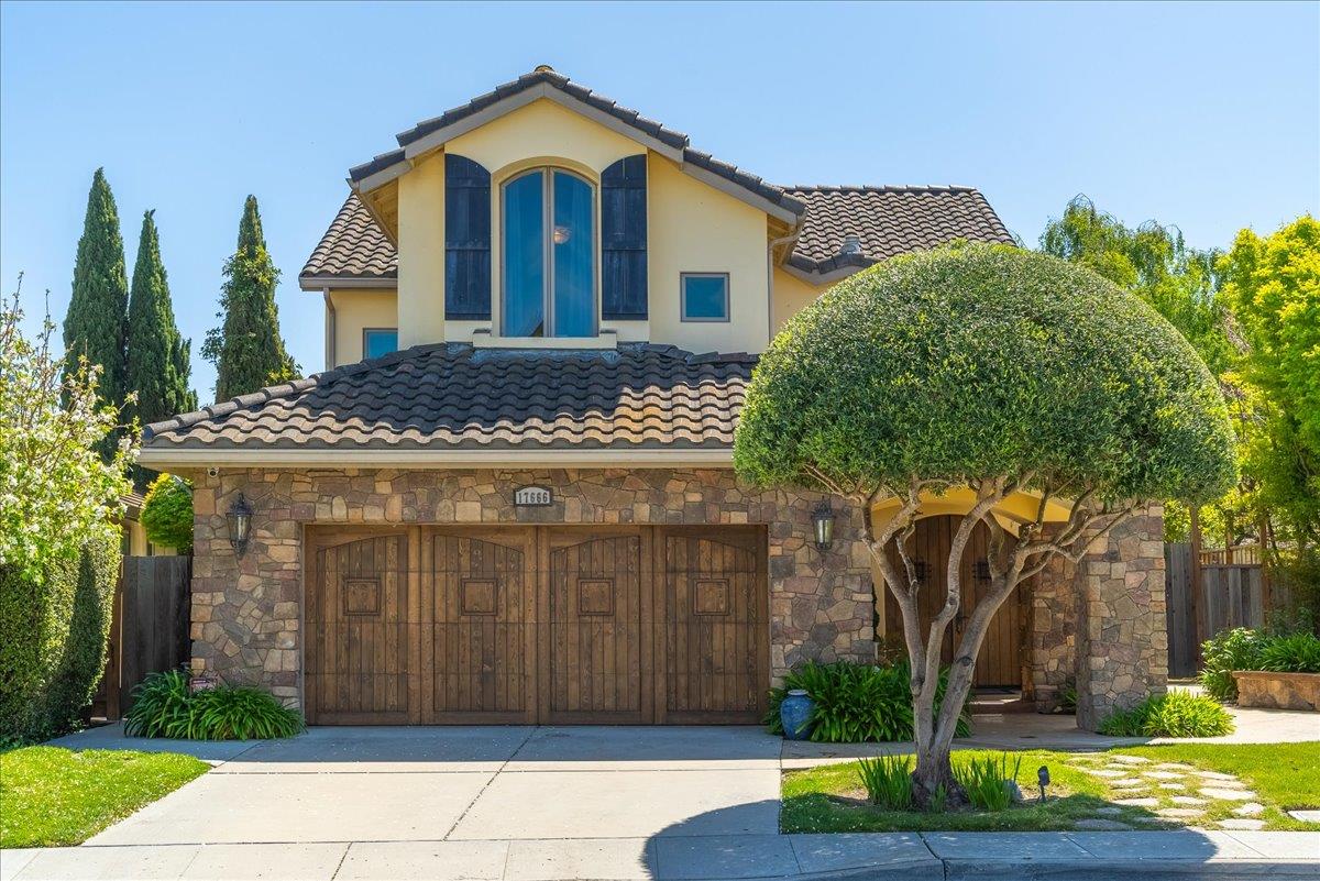 a front view of a house with garden