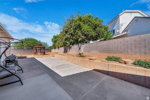 841 1010 S Street St. George, UT 84790 - Photo 32 of 33 Fenced backyard featuring a gazebo and a patio area