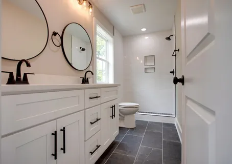 a bathroom with a toilet a sink and a mirror