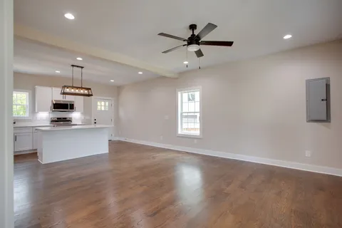 a view of kitchen with sink microwave and stove