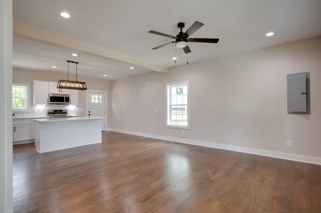 a view of kitchen with sink microwave and stove