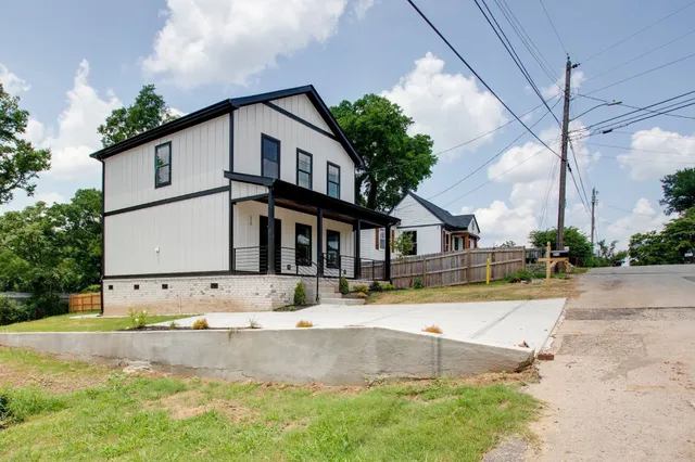a view of the house with a yard and plants