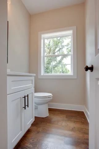 a bathroom with a toilet sink and window
