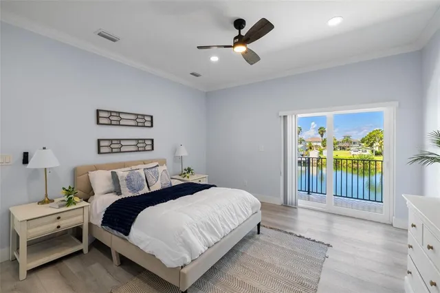 a bedroom with a bed and a ceiling fan