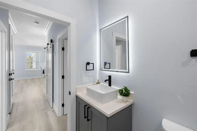 a bathroom with a sink a toilet and a mirror