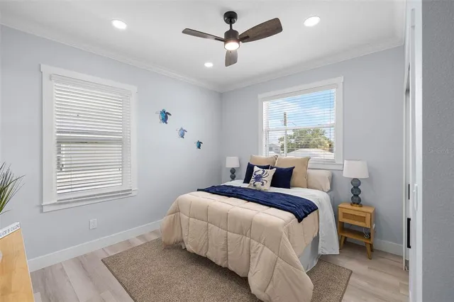 a bedroom with a bed next to a window