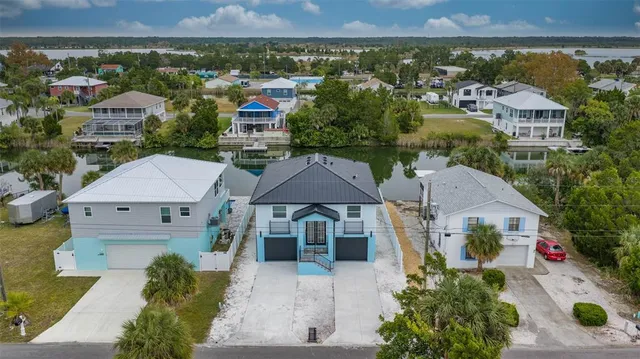 an aerial view of multiple houses with a yard