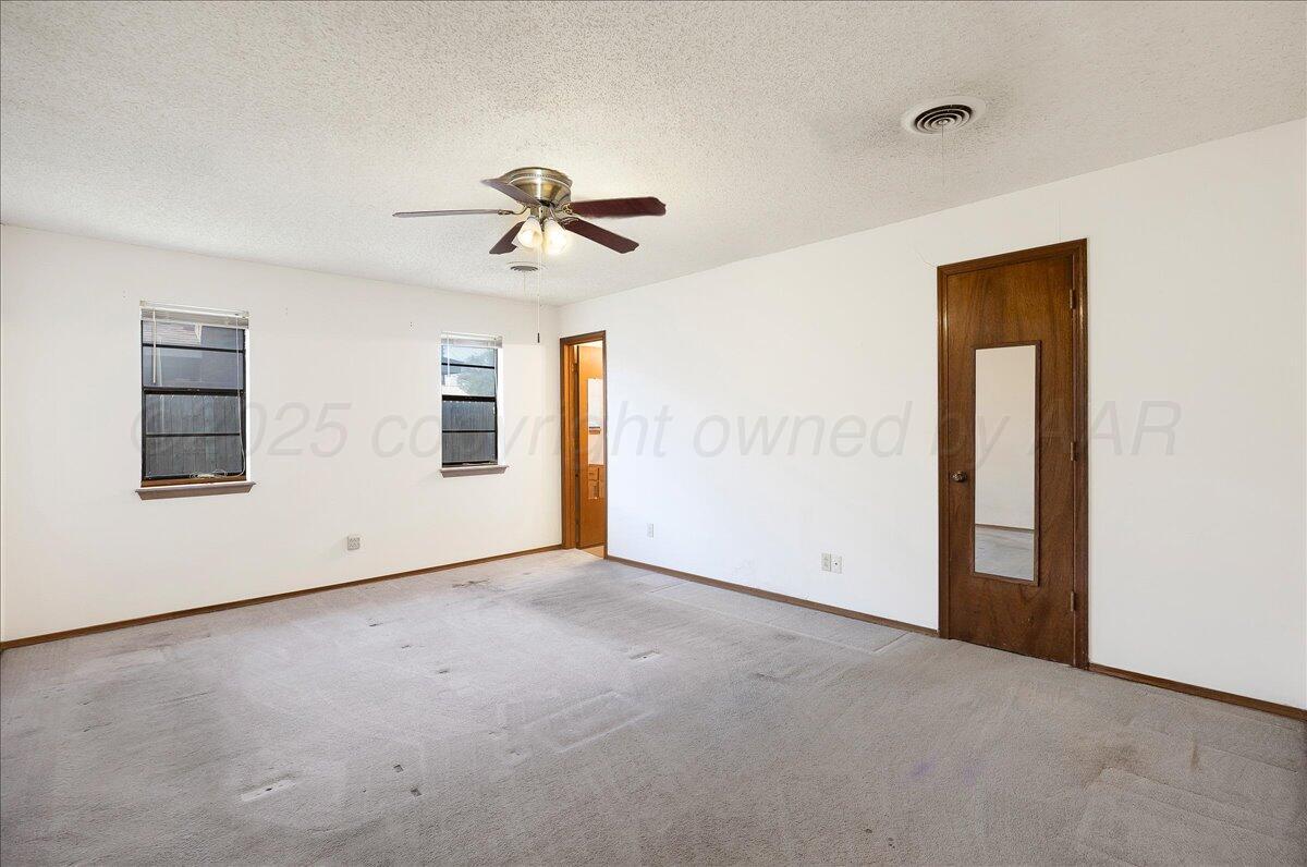 7210 Hatton Road Amarillo, TX 79110 - Photo 12 of 23 a view of empty room with windows