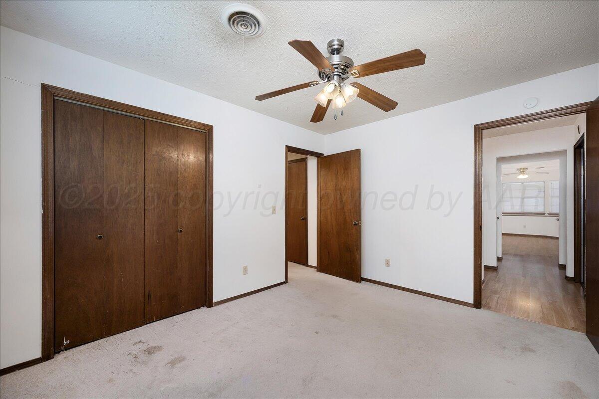 7210 Hatton Road Amarillo, TX 79110 - Photo 16 of 23 a view of a livingroom with a chandelier fan and closet area