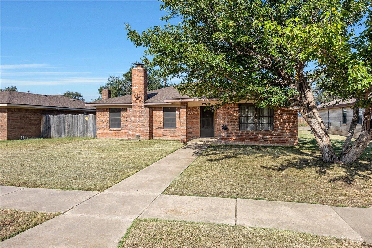 7210 Hatton Road Amarillo, TX 79110 - Photo 2 of 23 a front view of a house with garden