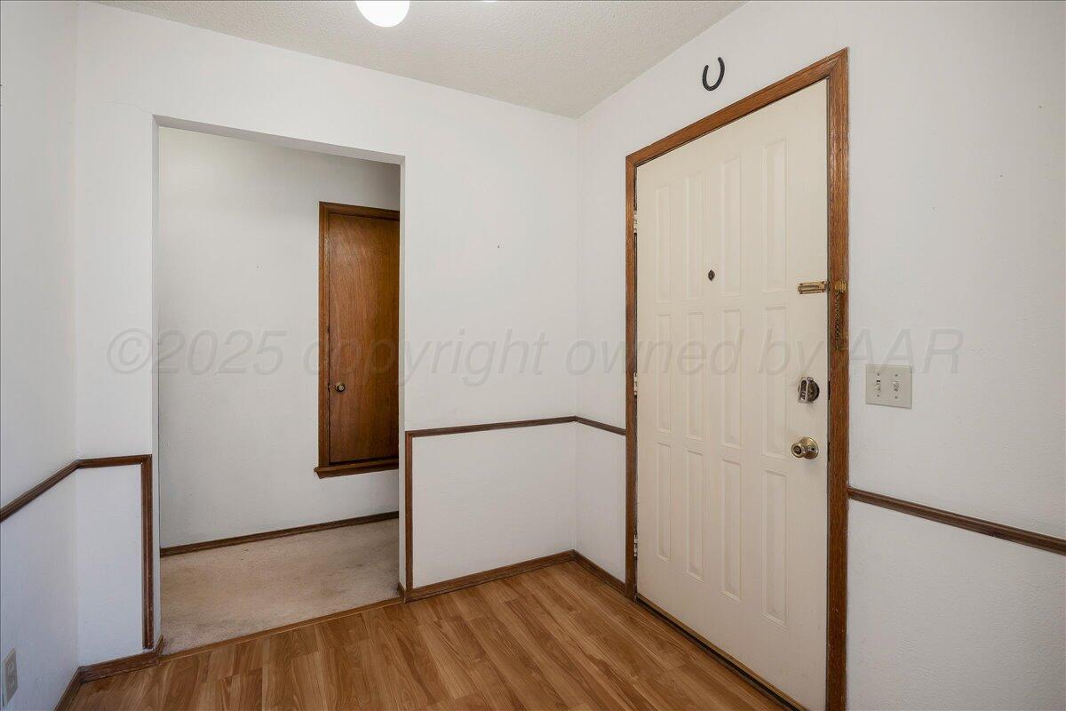 7210 Hatton Road Amarillo, TX 79110 - Photo 3 of 23 a view of front door with wooden floor