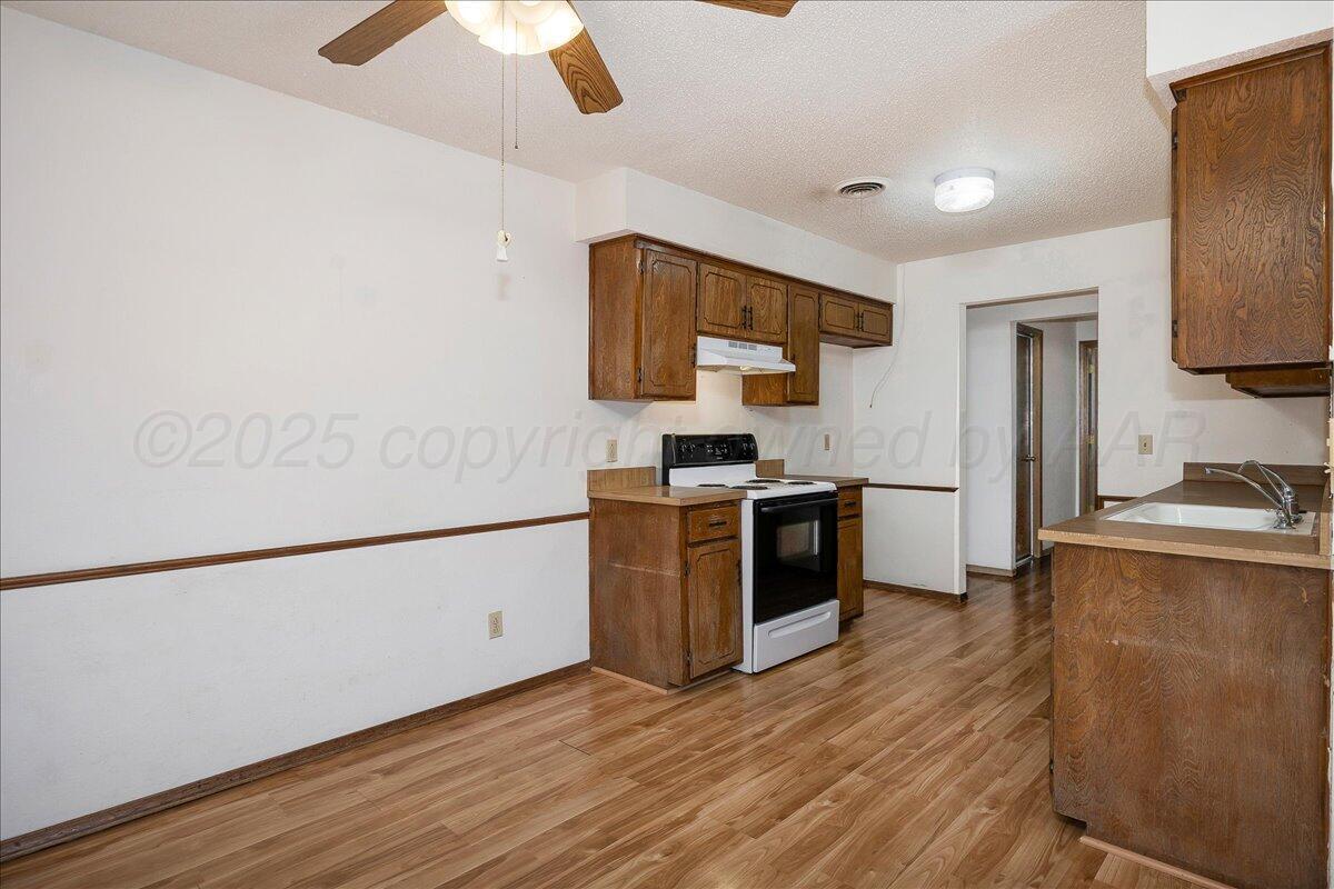 7210 Hatton Road Amarillo, TX 79110 - Photo 8 of 23 a kitchen with granite countertop a sink cabinets and stainless steel appliances