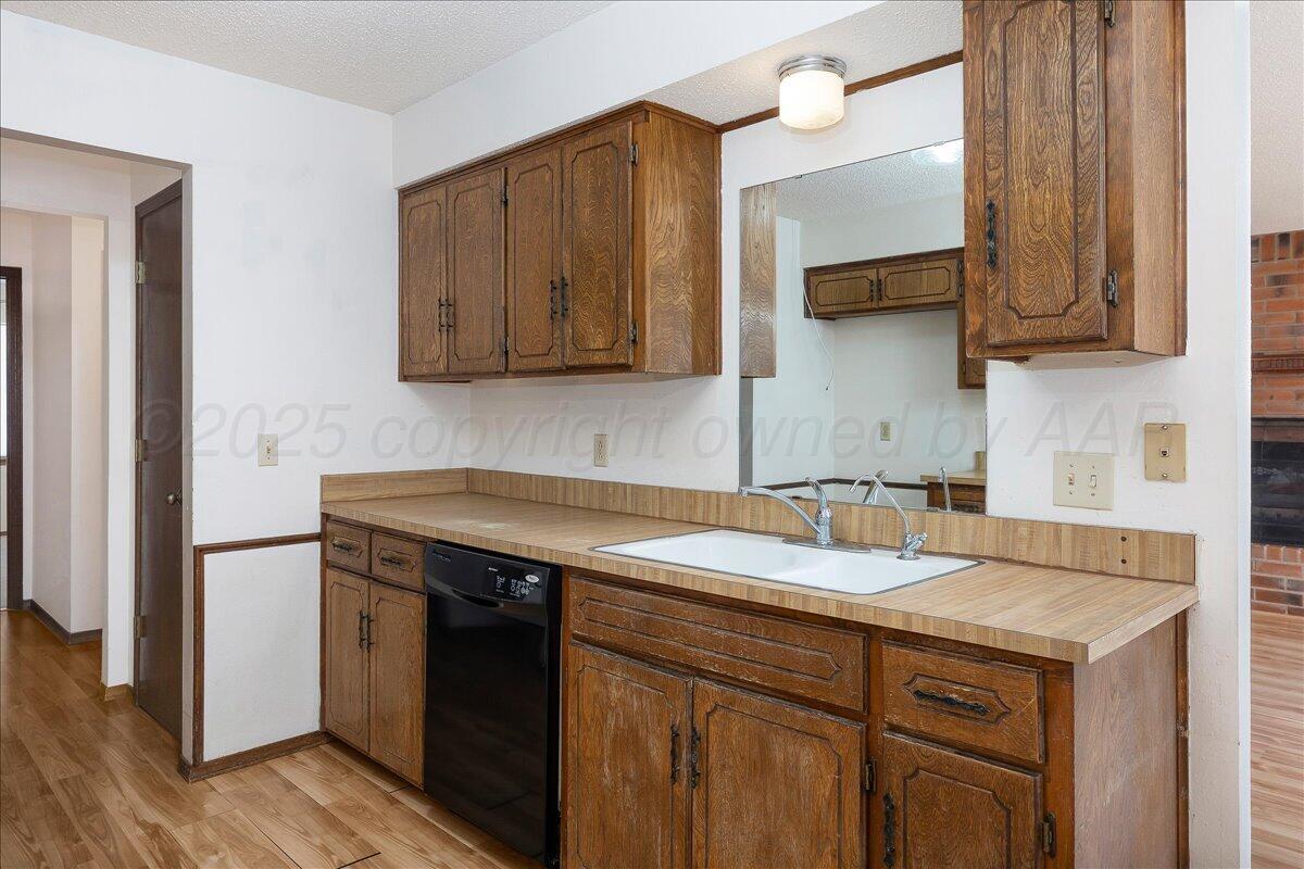 7210 Hatton Road Amarillo, TX 79110 - Photo 10 of 23 a sink a stove and cabinets