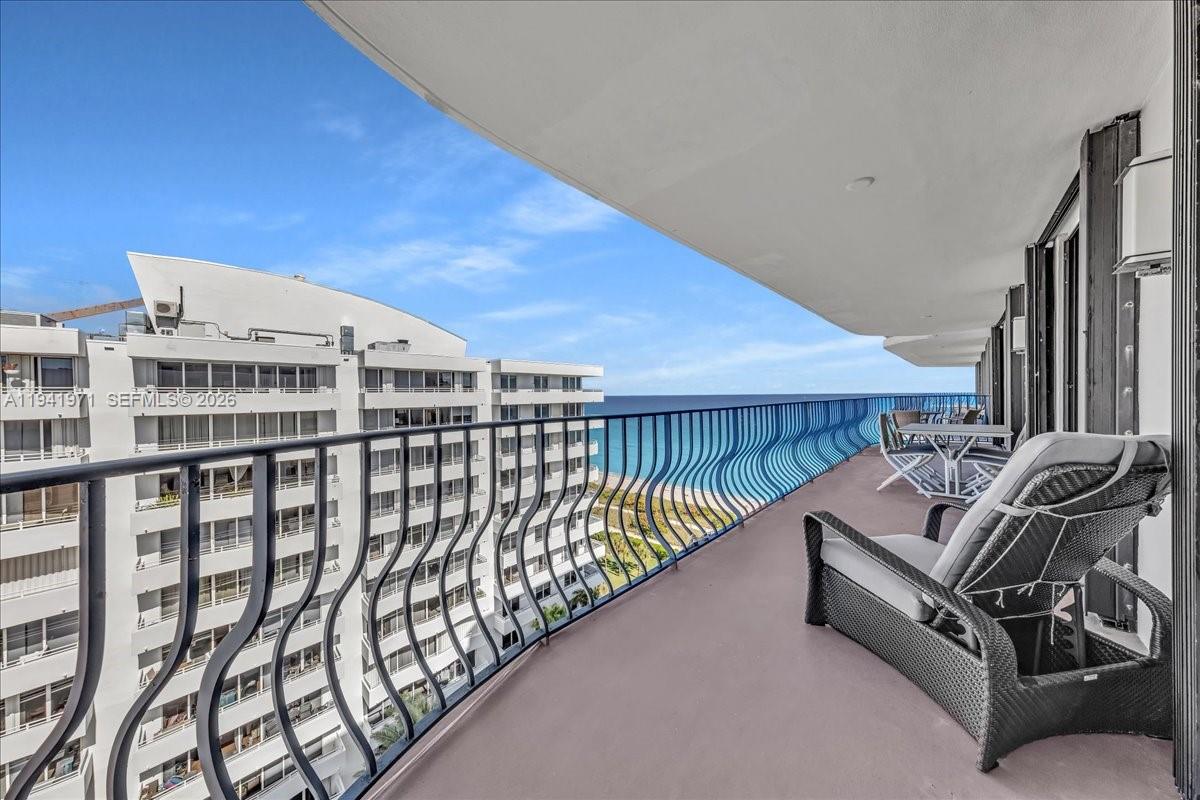 a view of a balcony with furniture