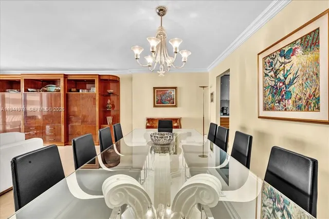 a view of a dining room with furniture large window and chandelier