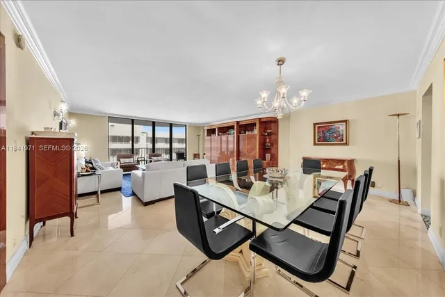 a view of a dining room with furniture large window and chandelier