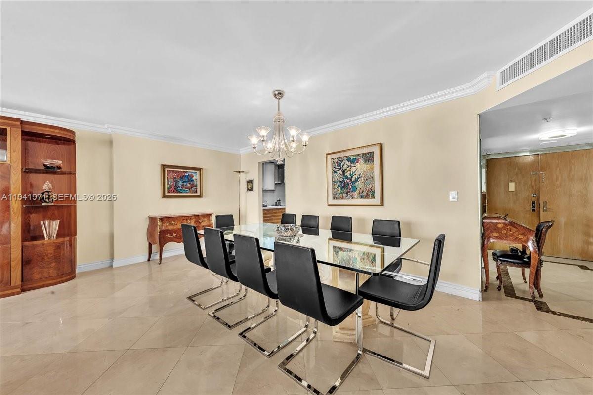 8877 Collins Avenue, Unit PH2 Surfside, FL 33154 - Photo 19 of 52 a view of a dining room with furniture