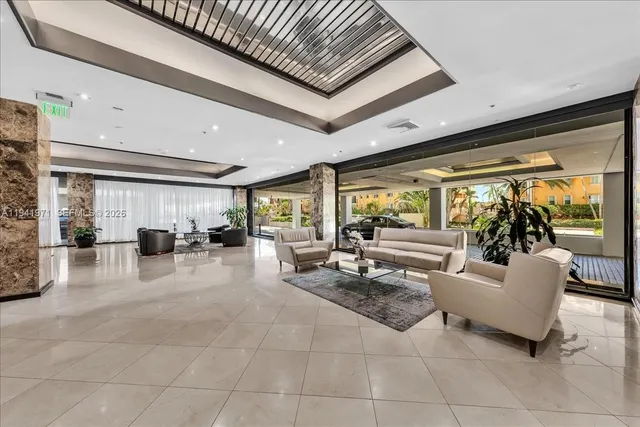 a living room with furniture and potted plants