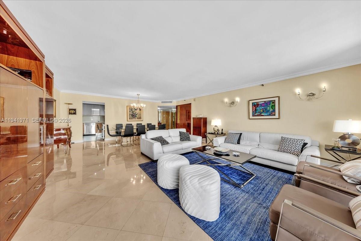 8877 Collins Avenue, Unit PH2 Surfside, FL 33154 - Photo 6 of 52 a living room with furniture and a large window