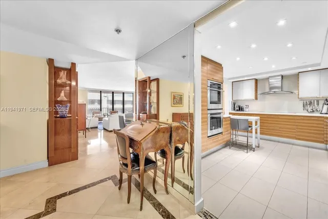 a kitchen with stainless steel appliances kitchen island granite countertop a refrigerator and cabinets