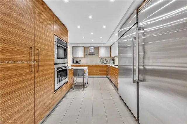 a kitchen with stainless steel appliances a sink and cabinets