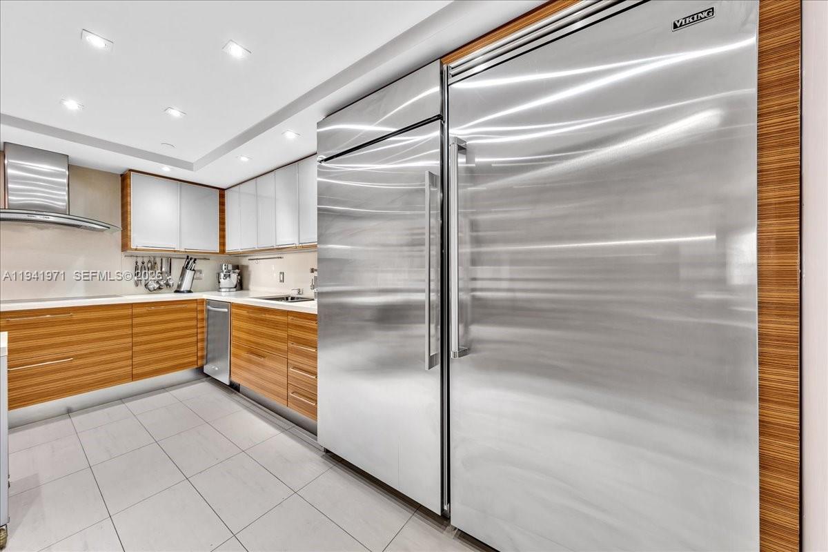 8877 Collins Avenue, Unit PH2 Surfside, FL 33154 - Photo 10 of 52 a kitchen with granite countertop stainless steel appliances and counter space