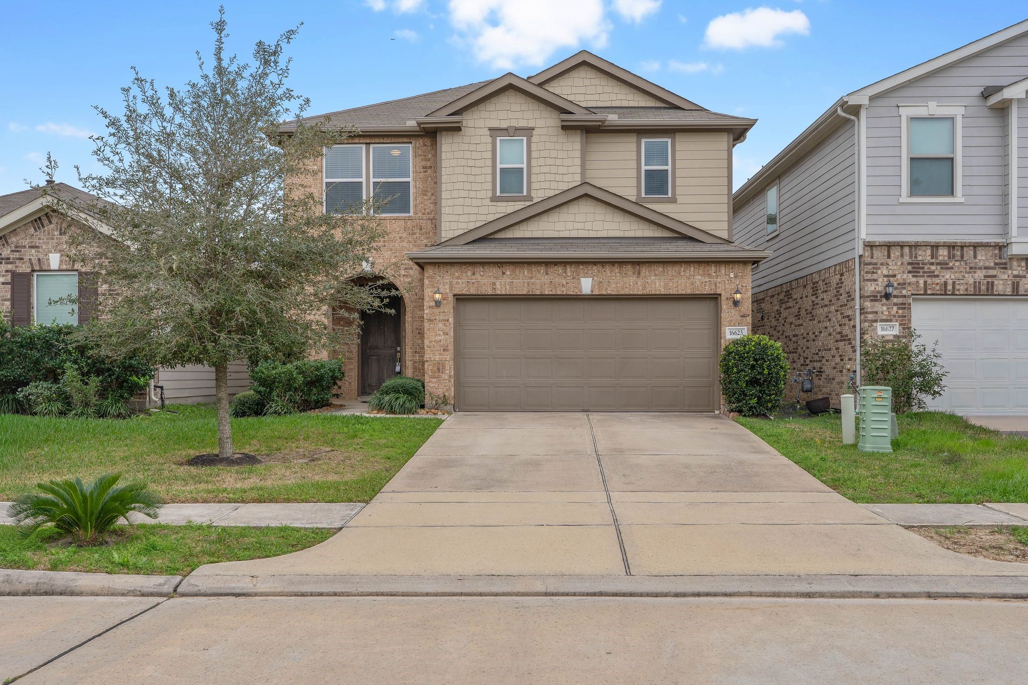 16623 Cliff Vale Court Houston, TX 77084 - Photo 1 of 34 a front view of a house with a yard and garage